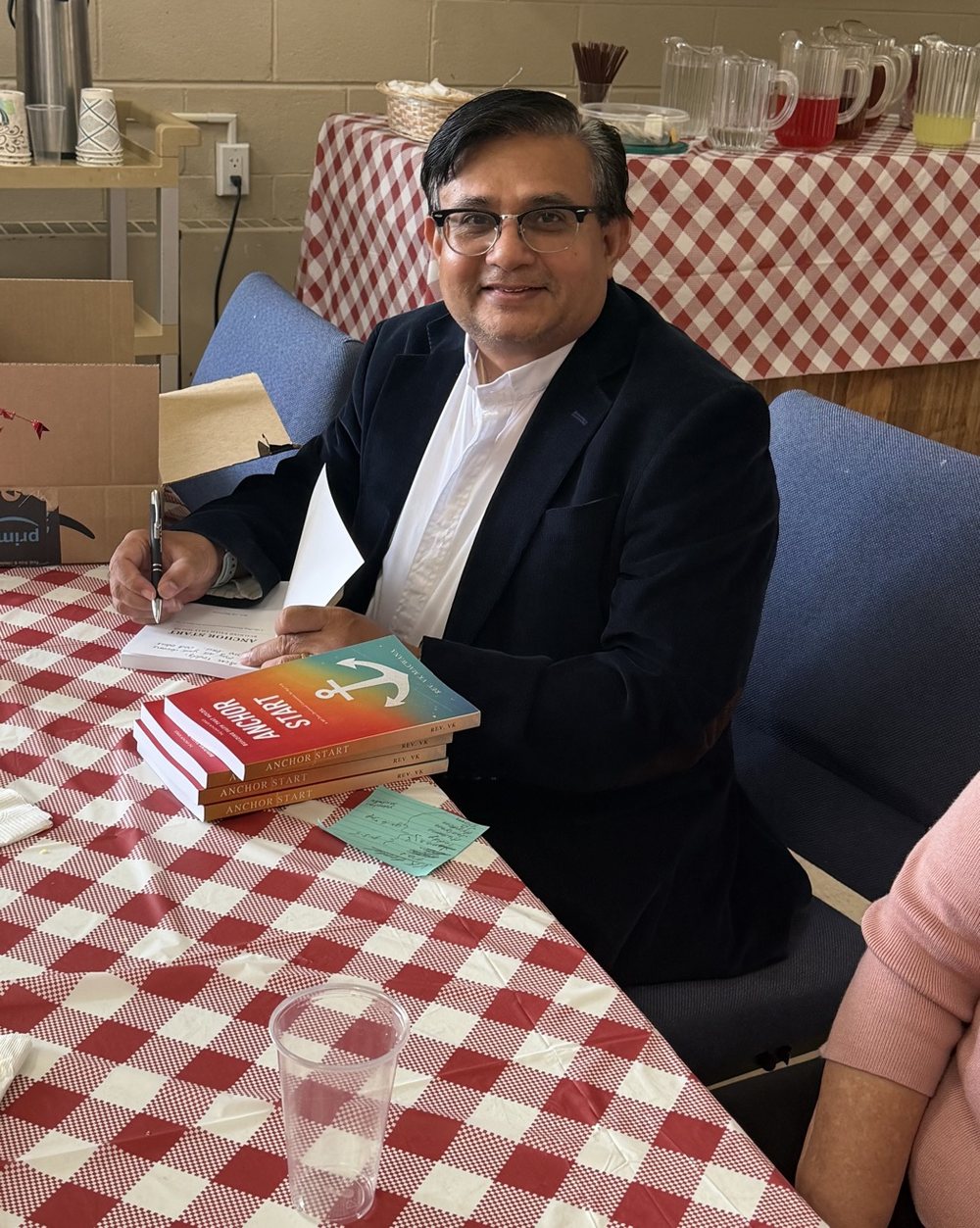 Rev. VK Macwana signing copies of Anchor Start at Morrisville UMC
